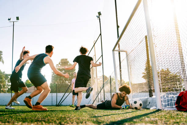 istock Players scoring goal in soccer training field 1263577648