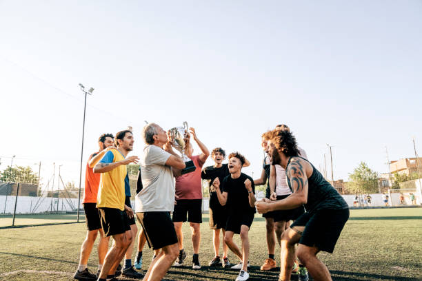 istock Soccer players cheering with trophy during summer 1263577659