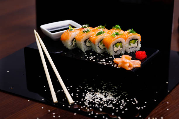 istock Sushi with salmon. Soy sauce, ginger, red caviar. Roles with red fish. 1263579014