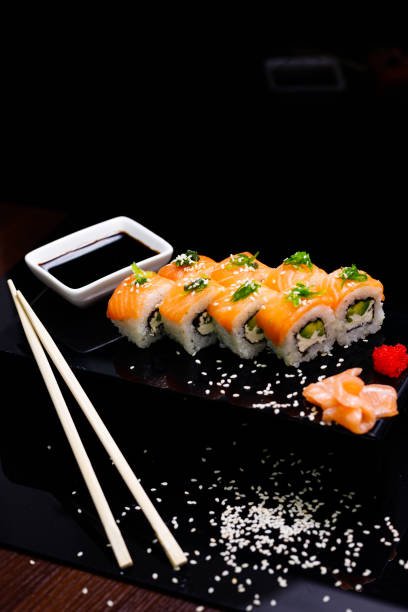 istock Sushi with salmon. Soy sauce, ginger, red caviar. Roles with red fish. 1263579022
