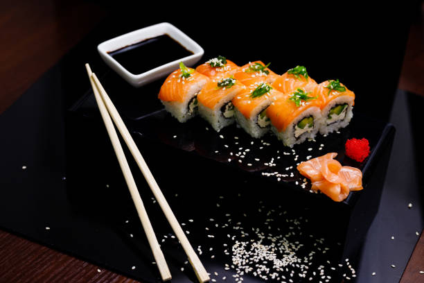 istock Sushi with salmon. Soy sauce, ginger, red caviar. Roles with red fish. 1263579040