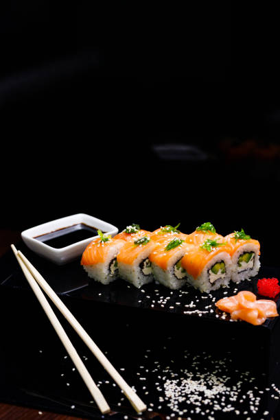 istock Sushi with salmon. Soy sauce, ginger, red caviar. Roles with red fish. 1263579063