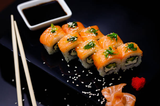 istock Sushi with salmon. Soy sauce, ginger, red caviar. Roles with red fish. 1263579080