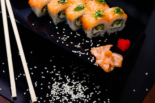 istock Sushi with salmon. Soy sauce, ginger, red caviar. Roles with red fish. 1263579108