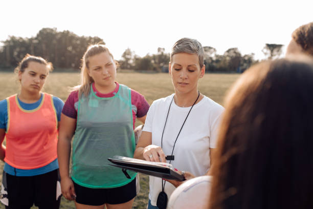 istock Coach and her female rugby team working on a play strategy 1263579178
