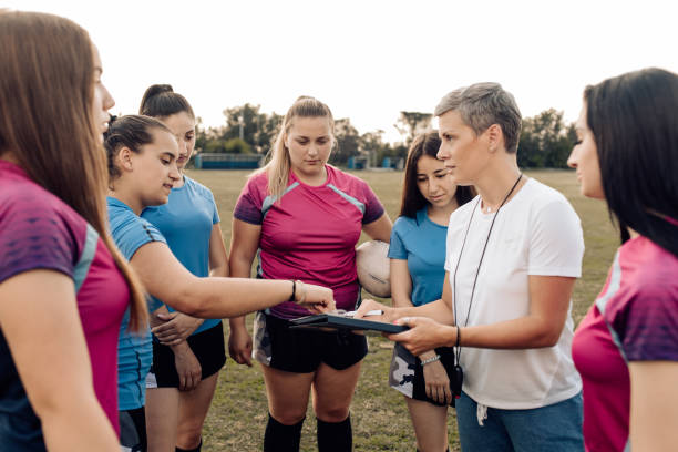 istock Coach guiding her female rugby team 1263579181