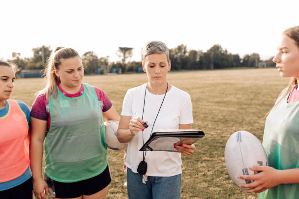 istock Coach working on a play strategy with a female rugby team 1263579194