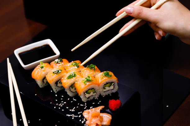 istock Sushi with salmon. Soy sauce, ginger, red caviar. Roles with red fish. 1263579271