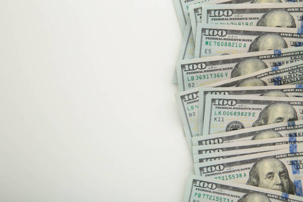 istock A pile of hundred dollar bills on white background with copy space 1263579530