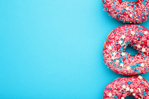 istock Donuts with icing on pastel blue background. Sweet donuts. 1263581230