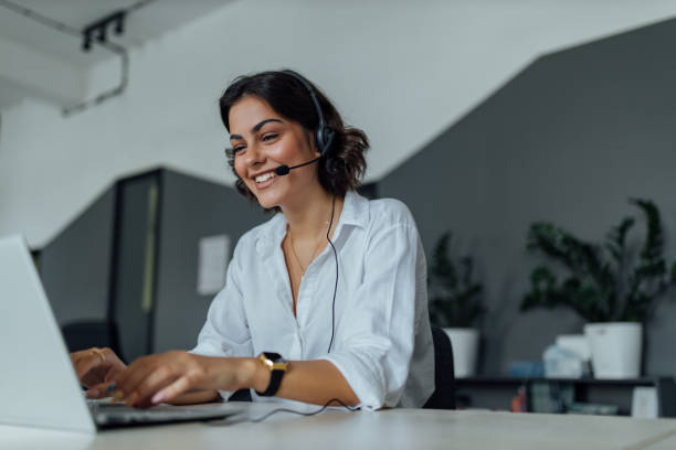 istock Female using headphones and microphone, smiling face. 1263582521