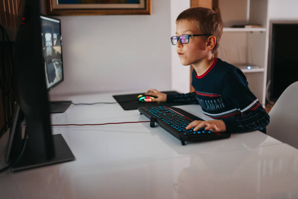 istock Boy playing video games on a computer at home 1263587018