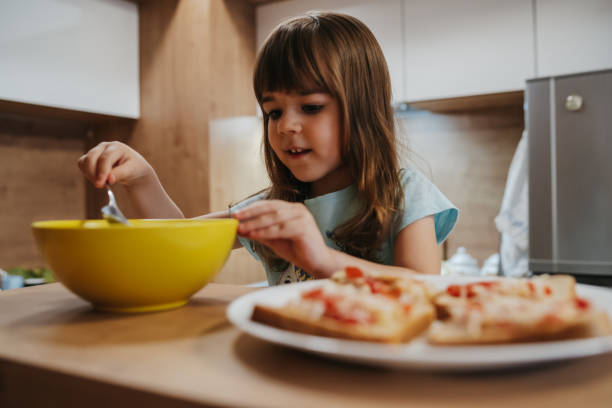 istock Cute girl making sandwiches 1263590197