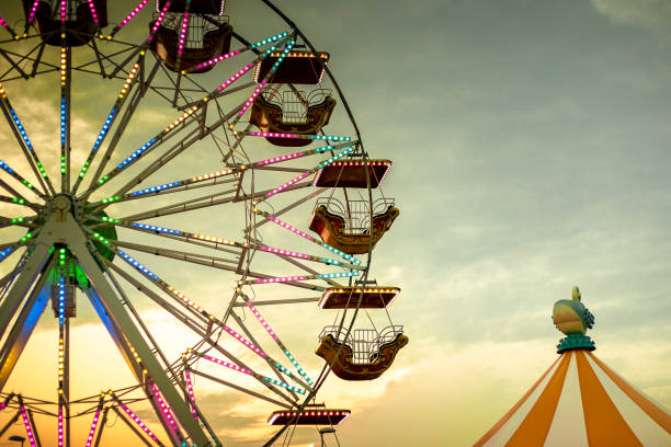 istock Ferris wheel and circus tent at sunset. retro wallpaper. 1263594037