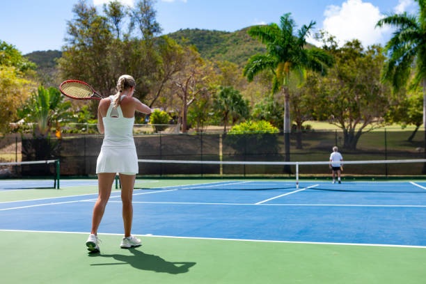 istock couple playing tennis in tropical climate 1263598387
