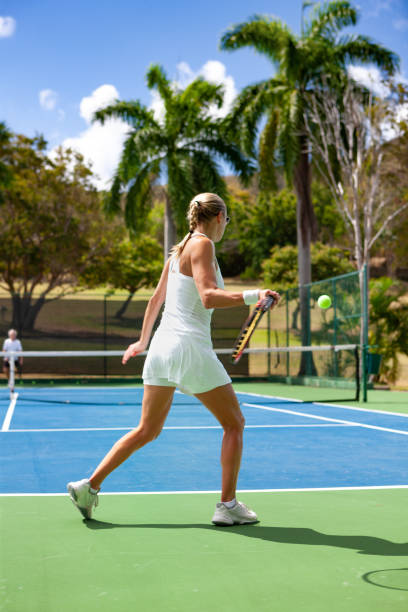 istock couple playing tennis in tropical climate 1263598388