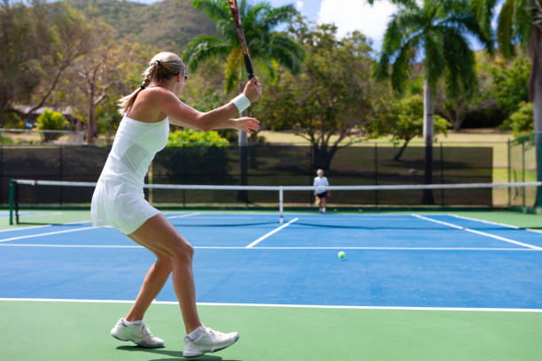istock couple playing tennis in tropical climate 1263598391