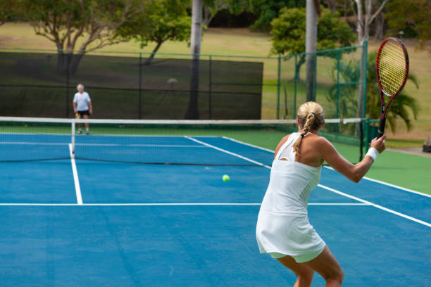 istock couple playing tennis in tropical climate 1263598393