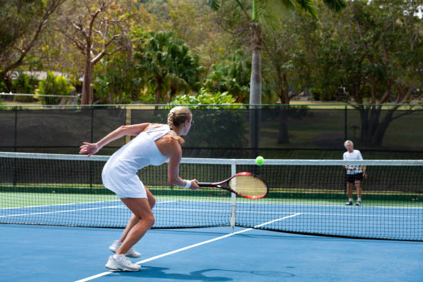 istock couple playing tennis in tropical climate 1263598401