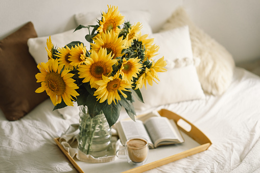 Still life in home interior of living room. Sunflowers, Coffee and open book. Read, Rest. Cozy Home