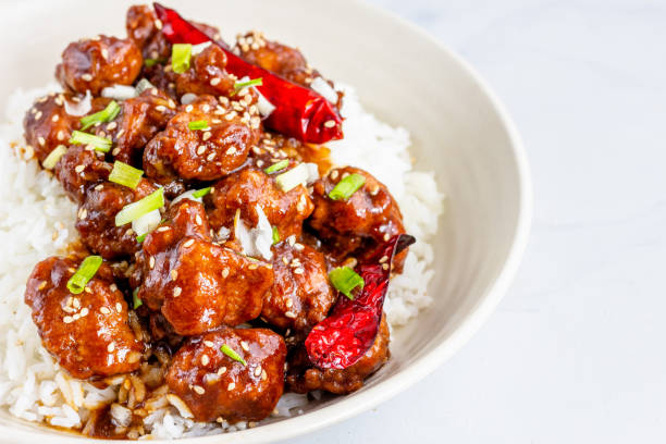 close-up photo of general tso's chicken on top of rice - chicken general tso food imagens e fotografias de stock