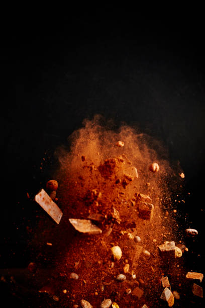Chocolate Food Explosion with Cocoa Powder, Chocolate Chips and Nuts Chocolate Food Explosion with Cocoa Powder, Chocolate Chips and Nuts slow motion photos stock pictures, royalty-free photos & images