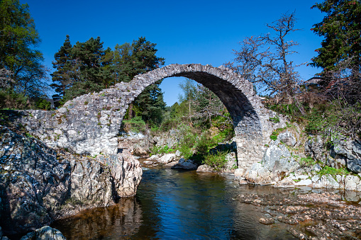 The iconic old stone bridge at Carrbridge in the Scottish Highlands.