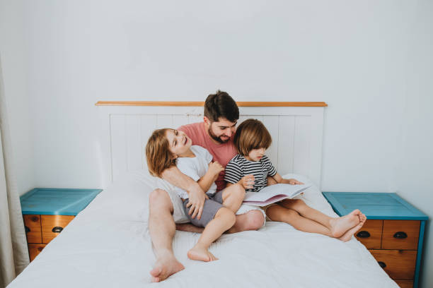 istock Father reading children's book to children 1263613859
