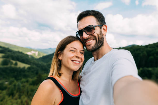 istock Young couple taking a selfie in the mountains 1263615514