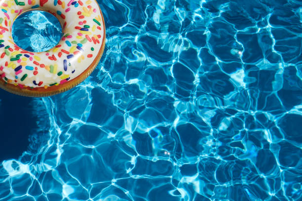 istock Inflatable donut ring in blue swimming pool 1263615796