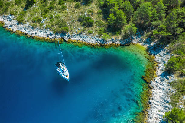 Anchored sailboat, view from drone Anchored sailboat at Dugi island, Croatia. High angle view from drone. dugi otok island stock pictures, royalty-free photos & images