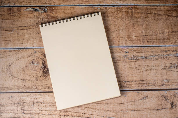 istock White sheet page notepad on a wooden brown background. 1263620157