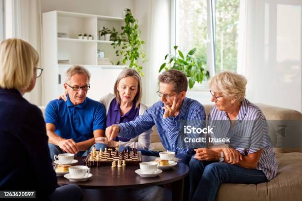Senior People Playing Chess In Retirement House Stock Photo - Download Image Now - 70-79 Years, Adult, Aging Process