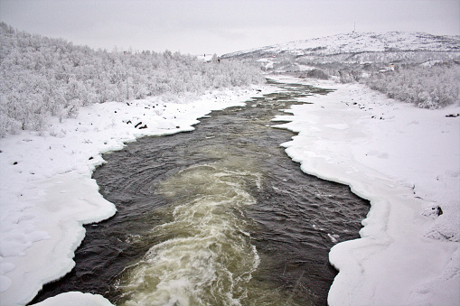 An icy and snowy river in Lapland between Norway and Finland