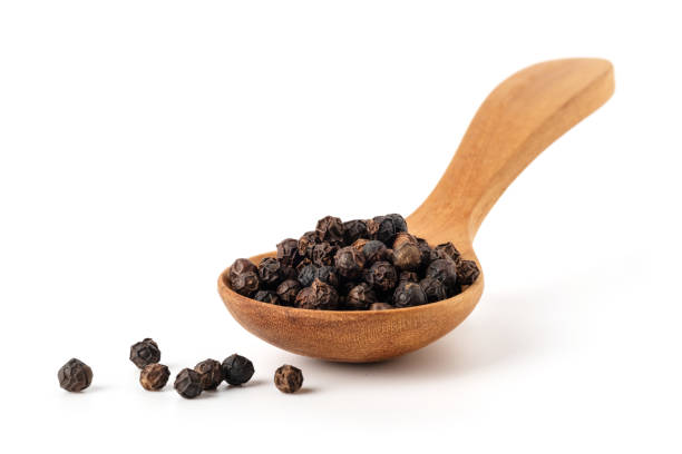 istock Black Peppercorns in wooden spoon 1263625744
