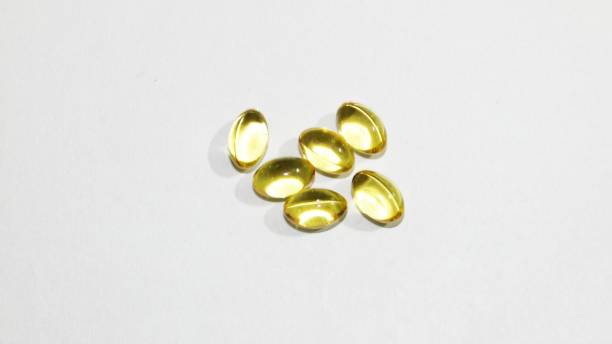 cod liver oil  or fish oil gel capsules. - fish oil vegetable capsule healthy eating imagens e fotografias de stock