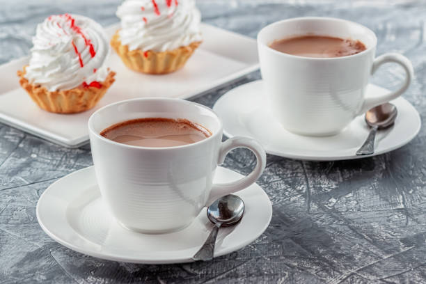 istock Freshly brewed aromatic coffee with cream and cake on gray background 1263627262