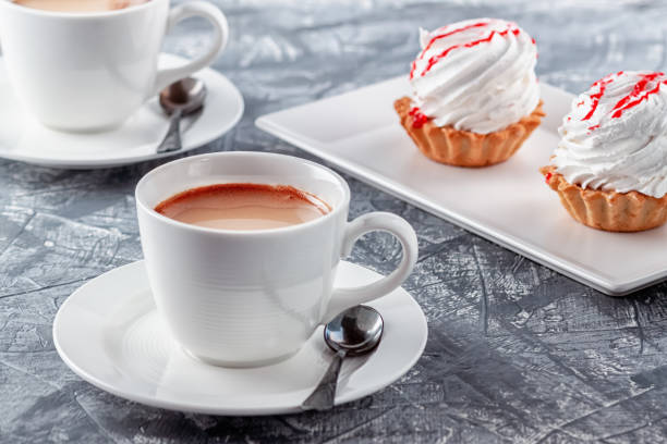 istock Freshly brewed aromatic coffee with cream and cake on gray background 1263627292