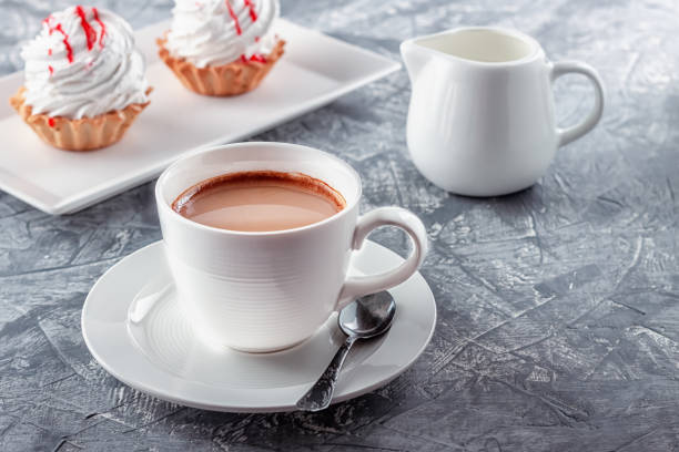 istock Freshly brewed aromatic coffee with cream and cake on gray background 1263627318