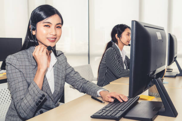 istock Business people wearing headset working in office 1263627369