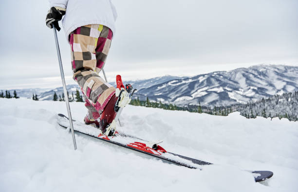 istock Man skier walking down snow-covered hill. 1263627769