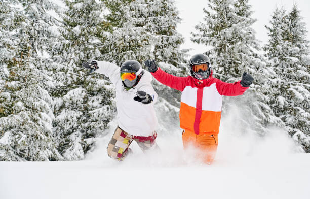 istock Two skiers having fun in winter coniferous forest. 1263627822