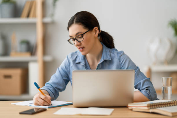 istock woman working on a tablet pc at home. 1263630656