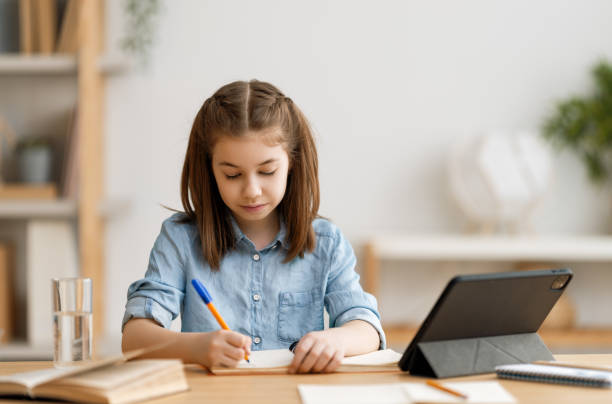 istock Girl doing homework or online education. 1263630668