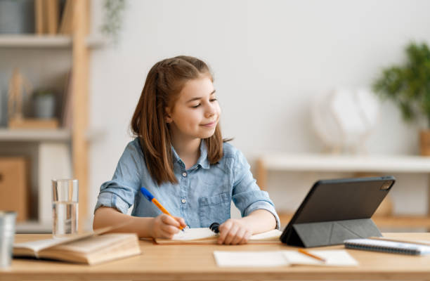istock Girl doing homework or online education. 1263630676