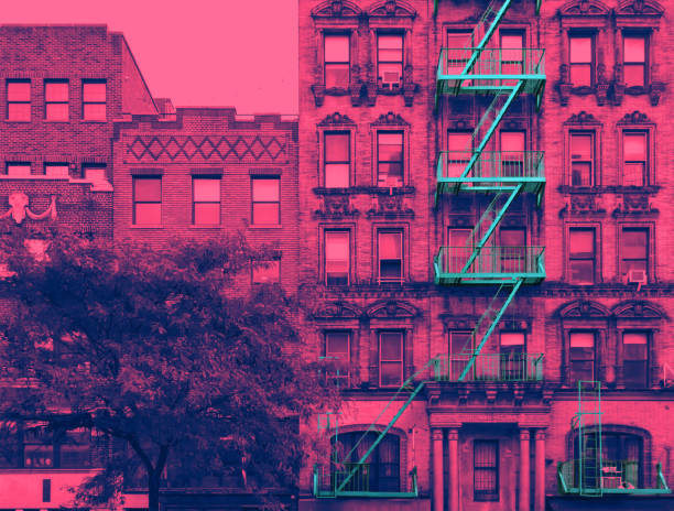 New York City building with fire escape in pink and blue vibrant colors stock photo