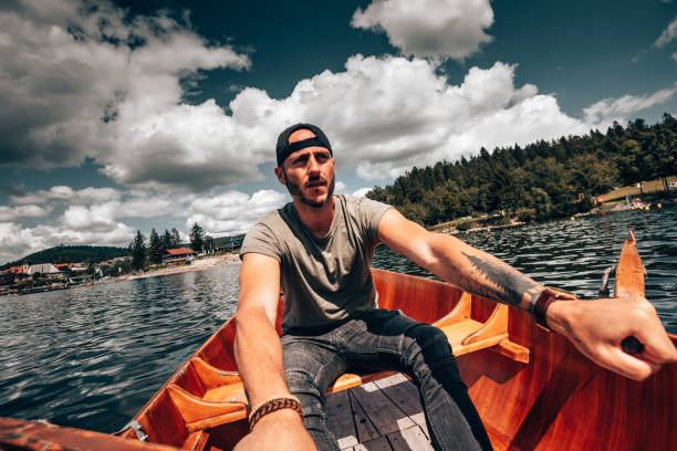 istock Young man rowing on a lake in Germany 1263634543