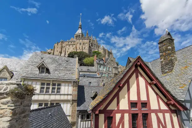 Photo of Mont St Michael Church Spire over Village Roofs in France