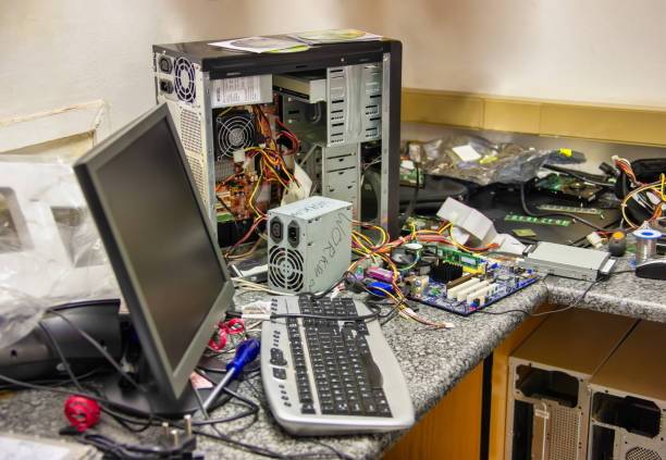 messy computer workshop with a lot of spare parts on the workbench