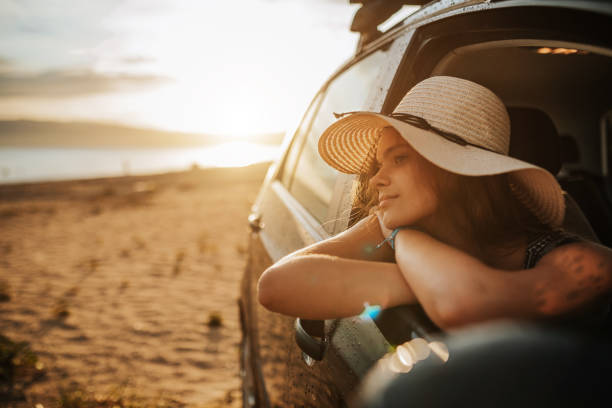 istock Young beautiful woman leaning on open car window on the beach 1263638742